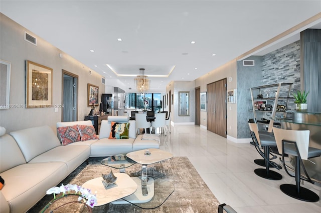 tiled living room featuring a notable chandelier