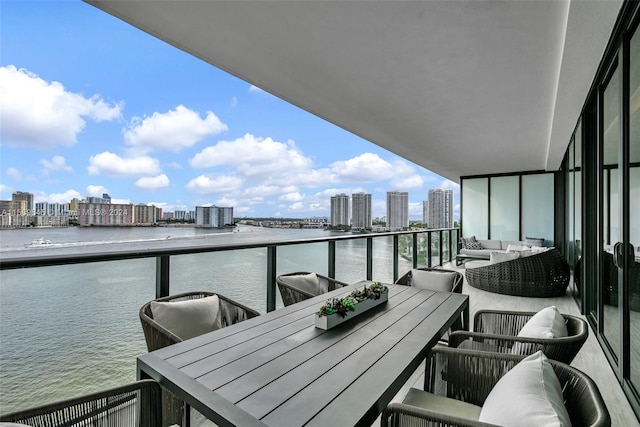 balcony featuring a water view and an outdoor hangout area