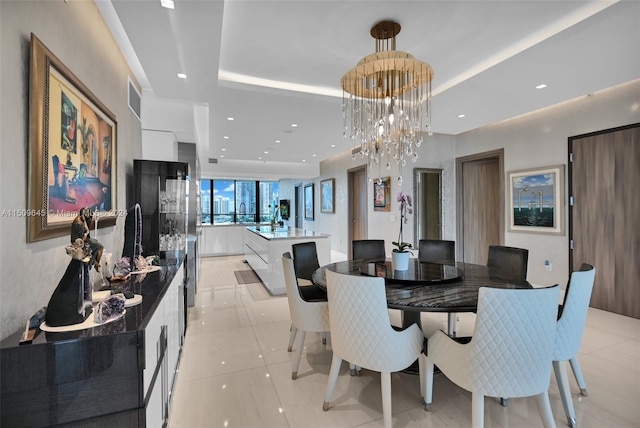 dining room featuring a chandelier and light tile floors