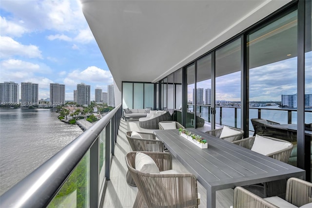 balcony with outdoor lounge area and a water view