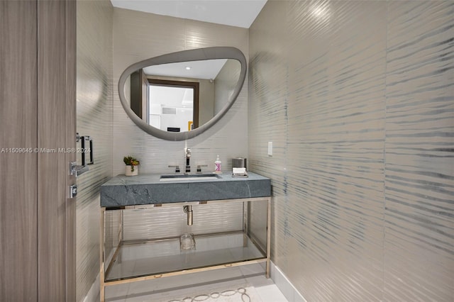 bathroom with tile walls, tile floors, and vanity