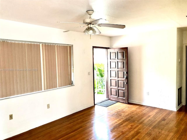 1256 NE 149th St, Miami, FL 33161 - foyer entrance featuring wood finished floors, ceiling fan, and baseboards