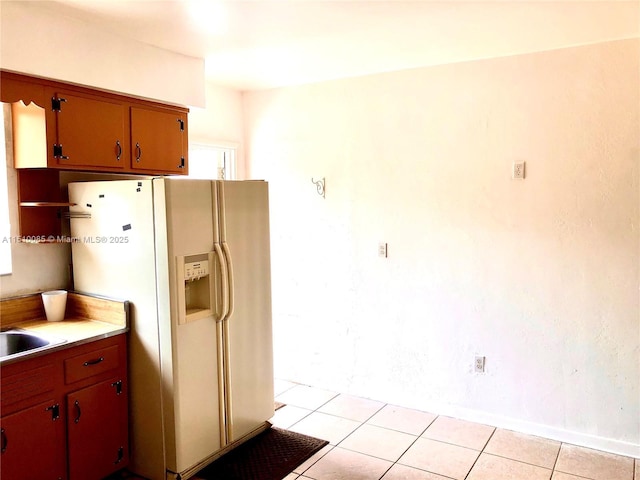 1256 NE 149th St, Miami, FL 33161 - kitchen with white fridge with ice dispenser, light countertops, and light tile patterned floors