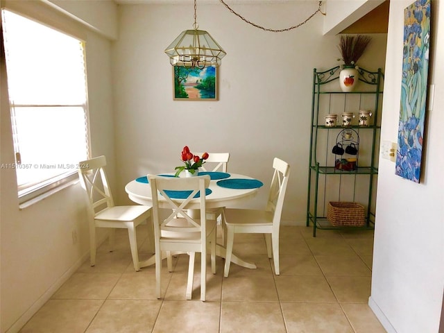 dining space featuring light tile floors