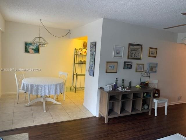 dining room with a textured ceiling and light wood-type flooring