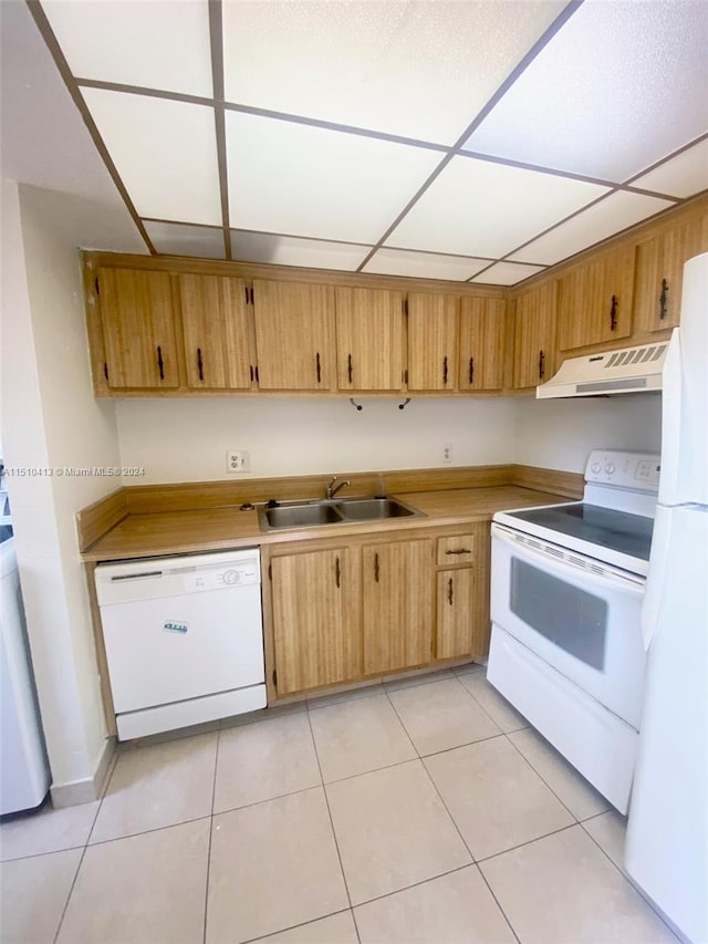 kitchen with sink, white appliances, a paneled ceiling, and light tile floors