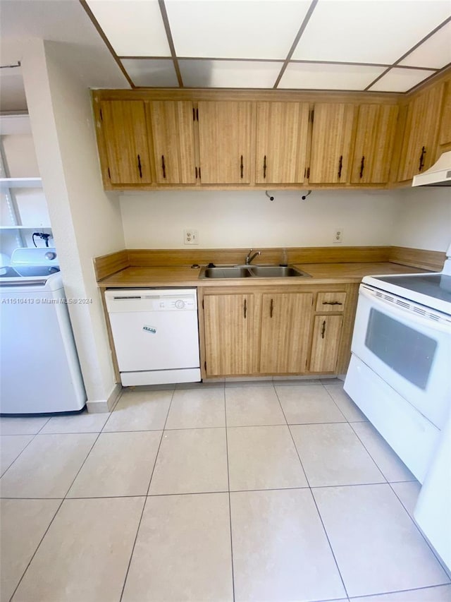 kitchen with washer / dryer, custom range hood, light tile flooring, sink, and white appliances