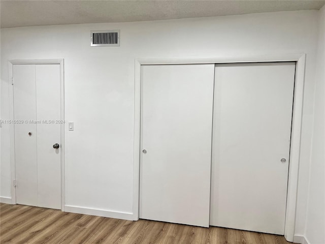 55 NW 204th St Unit 20, Miami Gardens, FL 33169 - unfurnished bedroom featuring visible vents, a closet, and light wood-style floors