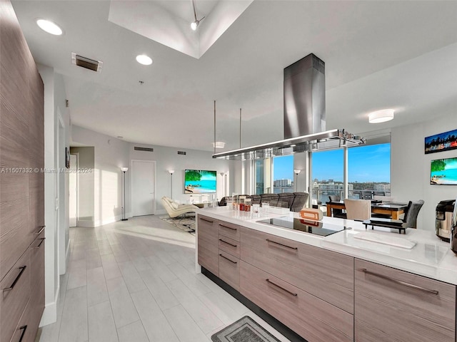 kitchen with island range hood and black electric cooktop