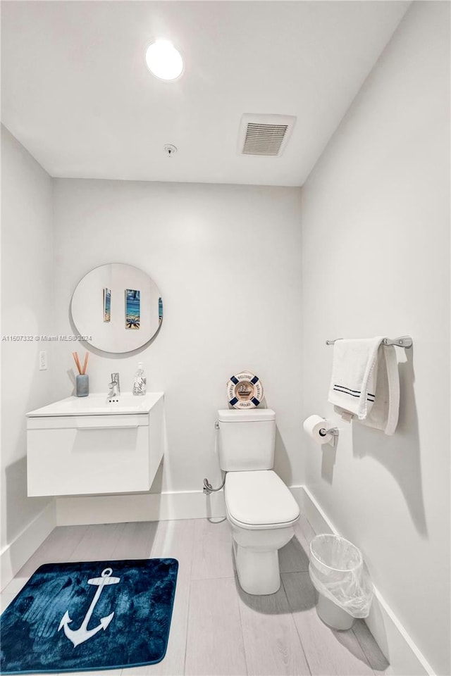 bathroom featuring vanity and toilet