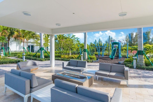 view of patio featuring a playground and an outdoor hangout area