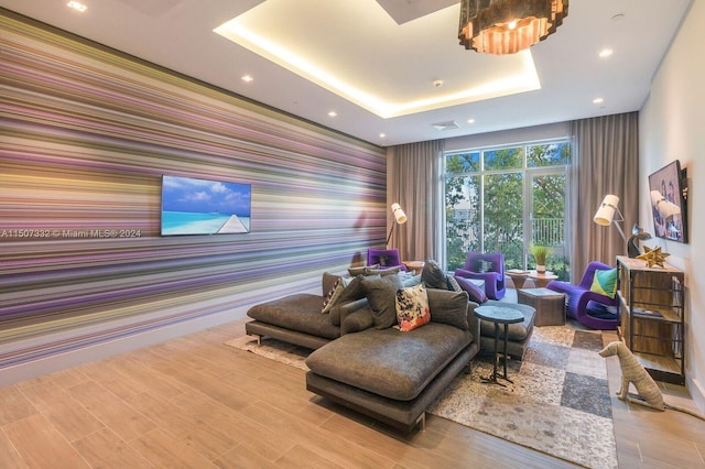 interior space featuring wood-type flooring and a tray ceiling