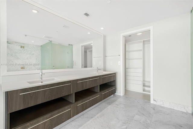 bathroom with vanity and a shower with shower door