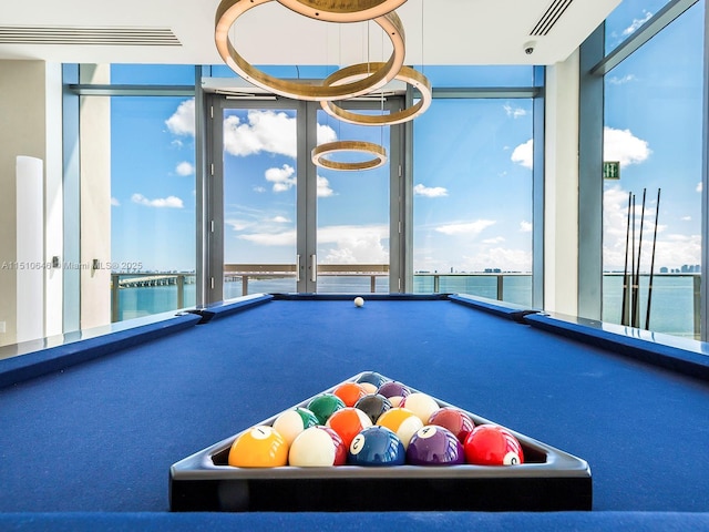 playroom with pool table and a water view