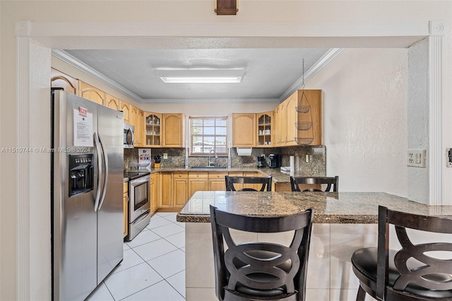 kitchen featuring stainless steel appliances, sink, kitchen peninsula, decorative backsplash, and light tile patterned flooring