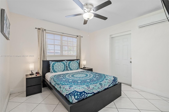 bedroom featuring light tile patterned flooring, an AC wall unit, and ceiling fan