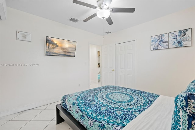 bedroom with light tile patterned flooring, a closet, and ceiling fan