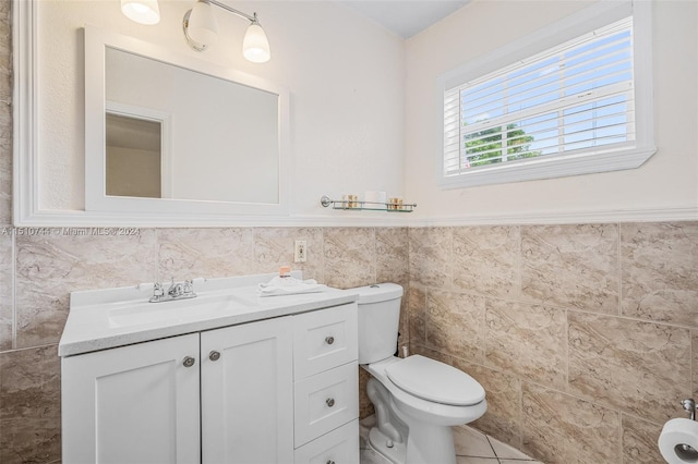 bathroom featuring vanity, tile walls, toilet, and tile patterned floors