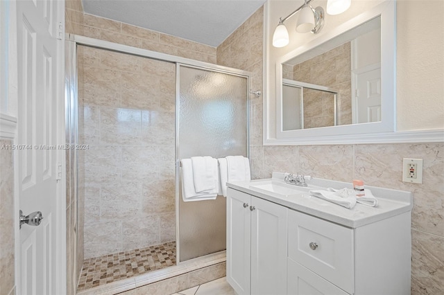 bathroom featuring vanity and a shower with door