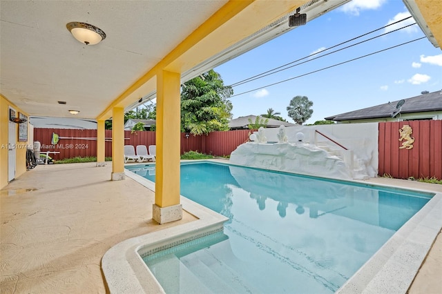 view of swimming pool with a patio