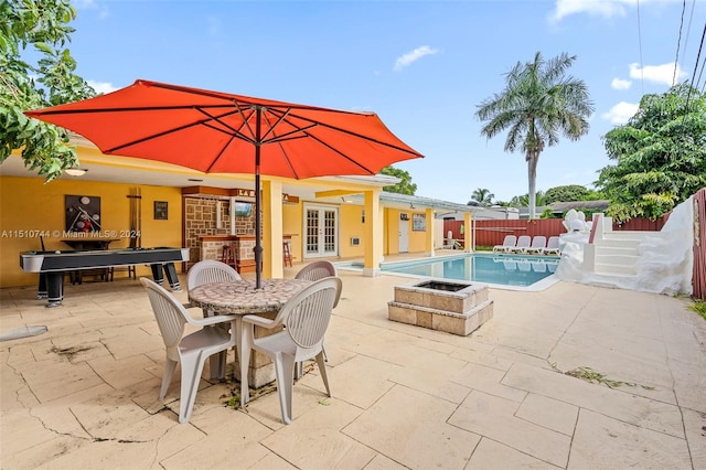 view of swimming pool with a patio area and french doors