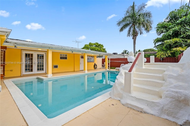 view of swimming pool with a patio and french doors