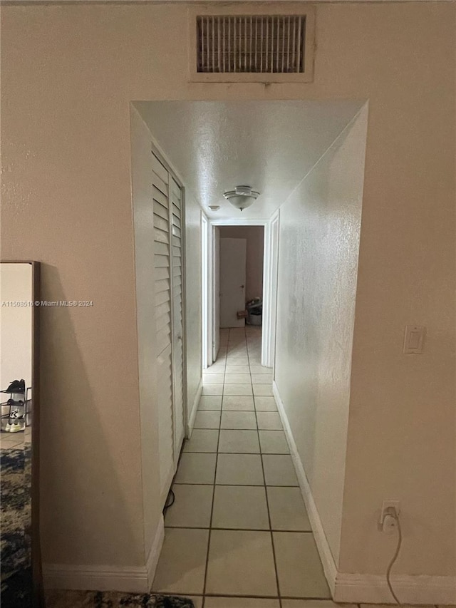 hallway with light tile floors