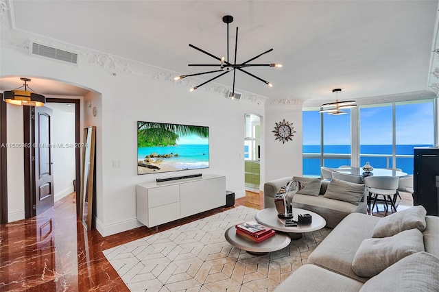 living room featuring a wealth of natural light and an inviting chandelier