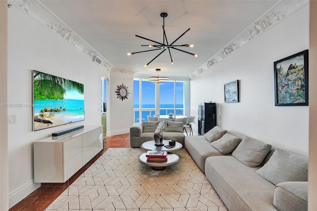 living room featuring hardwood / wood-style flooring, a notable chandelier, and ornamental molding