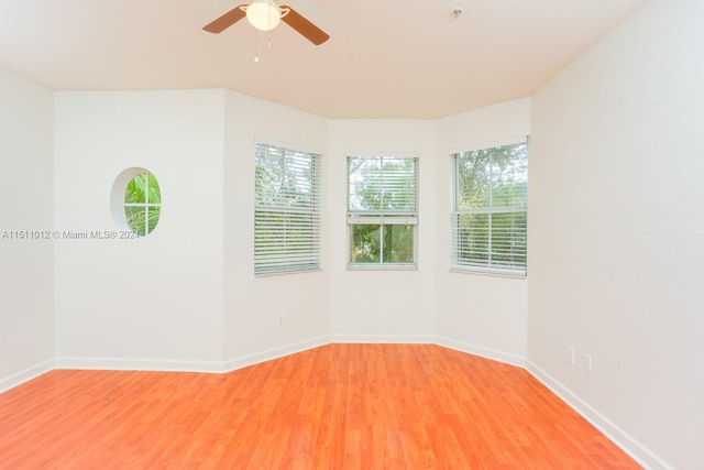 spare room with hardwood / wood-style floors and ceiling fan