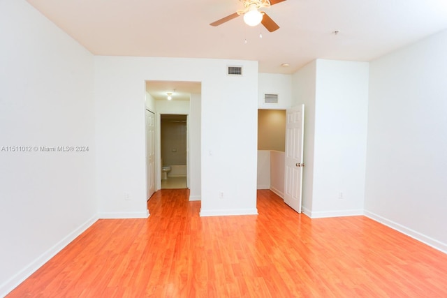 unfurnished bedroom with ceiling fan, a closet, and hardwood / wood-style floors