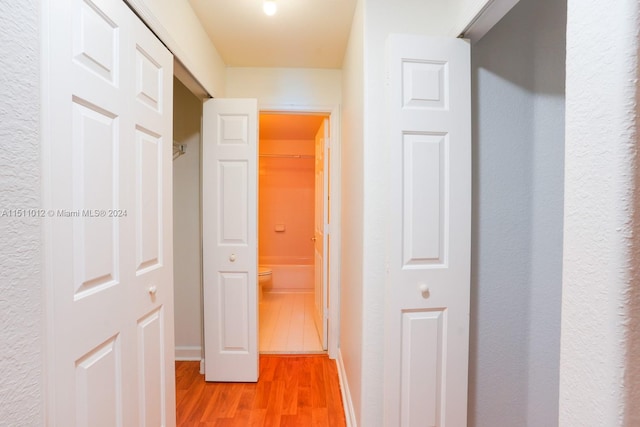 hallway with hardwood / wood-style floors