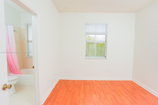 unfurnished room with hardwood / wood-style flooring