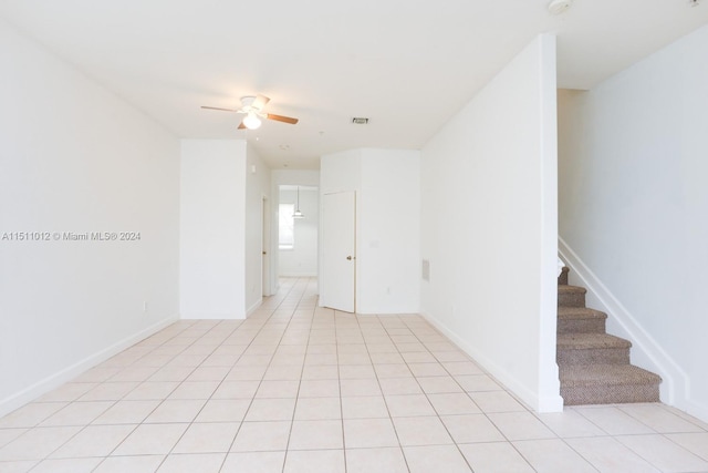 spare room featuring ceiling fan and light tile patterned floors