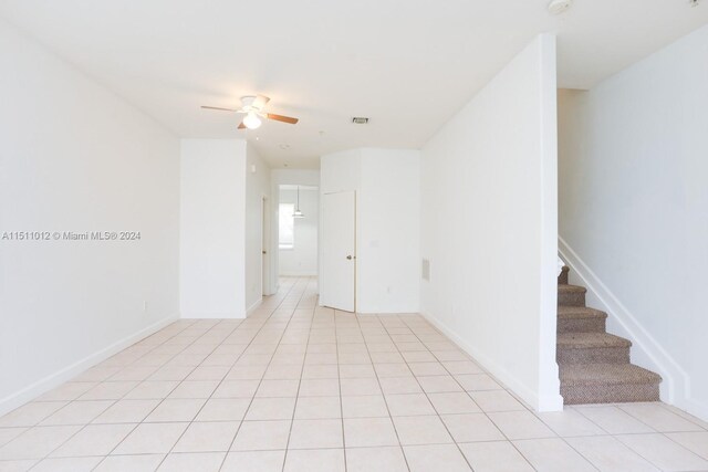 2150 Shoma Dr Unit 226, Royal Palm Beach, FL 33414 - empty room with a ceiling fan, stairway, light tile patterned flooring, and baseboards