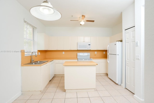 kitchen featuring light tile patterned flooring, a center island, sink, and white appliances