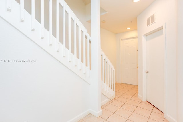 staircase featuring tile patterned floors