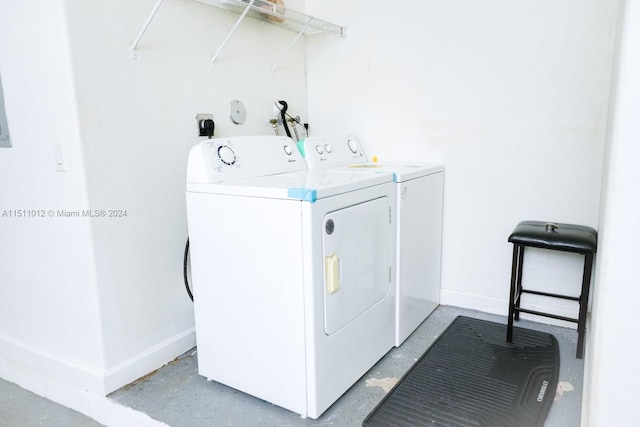 clothes washing area with washer and clothes dryer