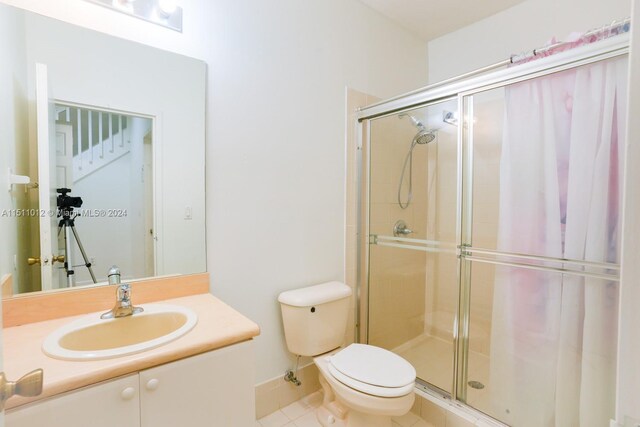2150 Shoma Dr Unit 226, Royal Palm Beach, FL 33414 - full bath with a stall shower, toilet, tile patterned flooring, vanity, and baseboards