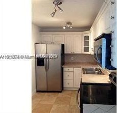 kitchen with white cabinetry, sink, and appliances with stainless steel finishes