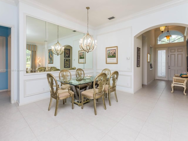 dining room with crown molding and light tile patterned floors