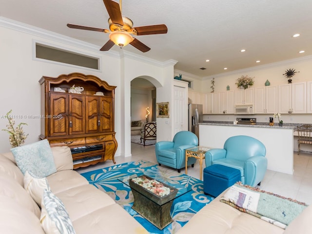 living room featuring ceiling fan, light tile patterned flooring, and ornamental molding