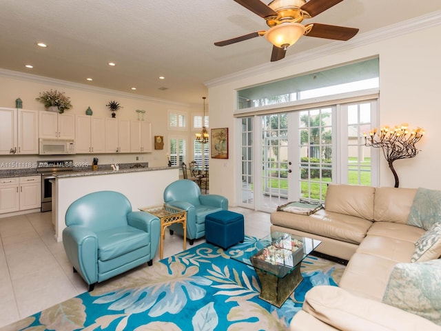 tiled living room featuring french doors, ceiling fan with notable chandelier, and ornamental molding