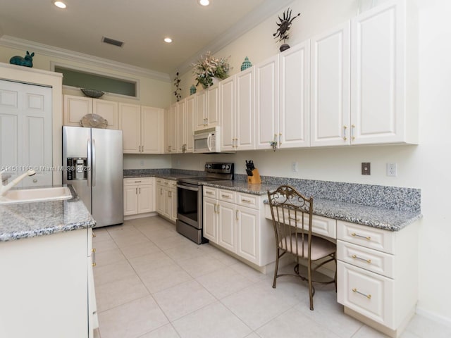 kitchen with white cabinets, crown molding, sink, and stainless steel appliances