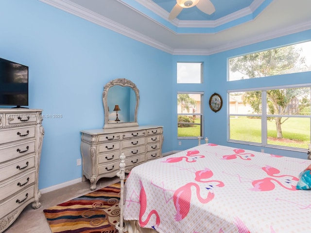 bedroom with light carpet, a tray ceiling, ceiling fan, and crown molding