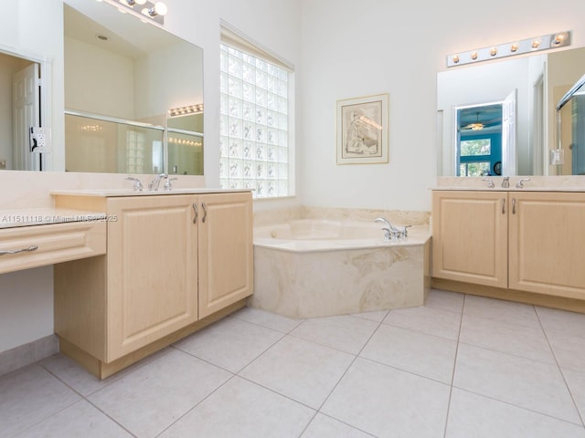 bathroom with tile patterned floors, vanity, and shower with separate bathtub