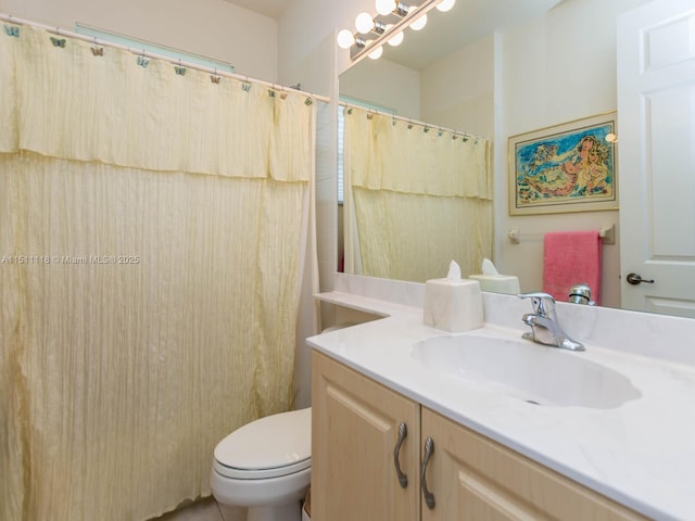 bathroom with vanity, toilet, and walk in shower