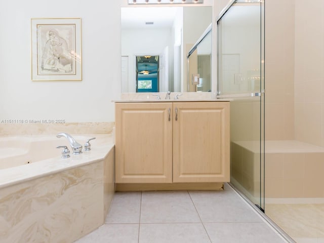 bathroom featuring tile patterned flooring, shower with separate bathtub, and vanity