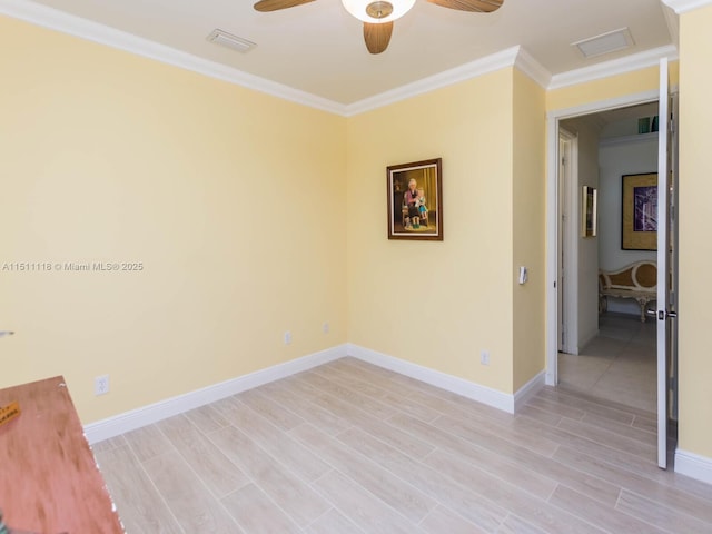 empty room featuring crown molding, ceiling fan, and light hardwood / wood-style floors