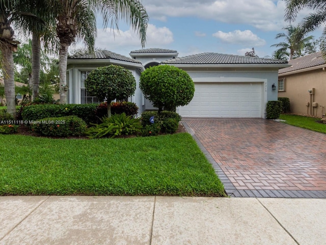 view of front of house with a garage and a front yard